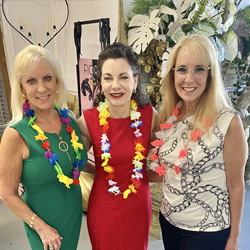 Three women smiling at the camera.